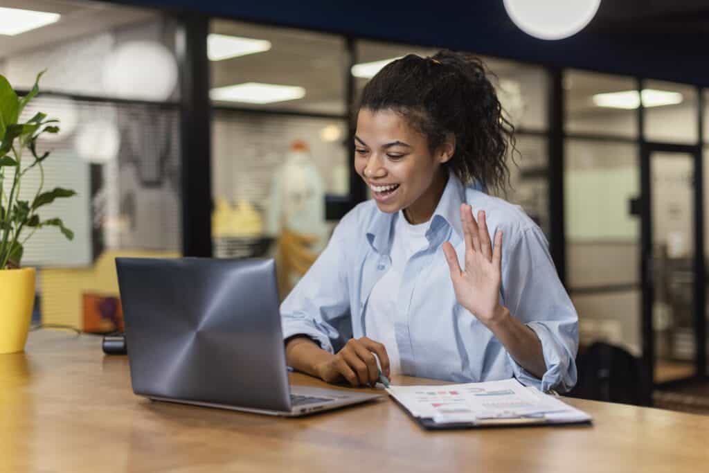 smiley-woman-having-a-video-call-in-the-office