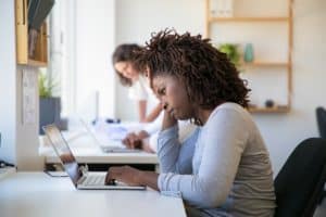 new hire attending a virtual onboarding program on laptop